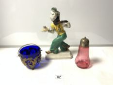 A PORCELAIN BLACKAMOOR FIGURE 30CMS, A CRANBERRY SIFTER AND A BLUE GLASS AND PLATED SUGAR BOWL