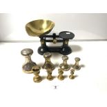 A SET OF IRON AND BRASS KITCHEN SCALES WITH EIGHT BRASS BELL WEIGHTS