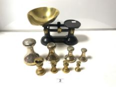 A SET OF IRON AND BRASS KITCHEN SCALES WITH EIGHT BRASS BELL WEIGHTS