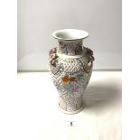 A 20TH CENTURY PIERCED PORCELAIN VASE WITH FLORAL EMBOSSED AND ENCRUSTED DECORATION, 24CMS