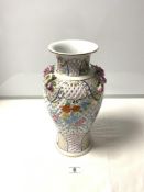 A 20TH CENTURY PIERCED PORCELAIN VASE WITH FLORAL EMBOSSED AND ENCRUSTED DECORATION, 24CMS