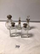 A CUT GLASS AND SILVER TOP PEAR-SHAPED SCENT BOTTLE, TWO OTHER SILVER MOUNTED SCENT BOTTLES AND A