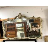 1930S SHAPED WALL MIRROR PAINTED CREAM AND GILT, 100 X 66CMS