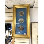 THREE FRAMED POT LIDS IN A GILT GLAZED FRAME, 52 X 21CMS