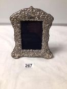 A HALLMARKED SILVER EMBOSSED PHOTO FRAME 20 X 17CMS
