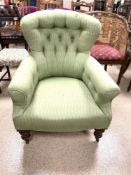 A VINTAGE BUTTON BACK ARMCHAIR WITH GREEN HERRINGBONE PATTERN ON ORIGINAL CASTORS