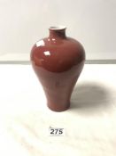 A 20TH CENTURY CHINESE RED GROUND BOTTLE VASE, 21CMS