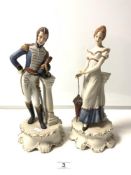 A PAIR OF CONTINENTAL BISCUIT PORCELAIN FIGURES OF A 19TH CENTURY NAVAL OFFICER AND A MAIDEN