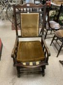 A LATE VICTORIAN WALNUT FRAMES ROCKING CHAIR WITH SPINDEL SUPPORTS