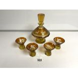 A BOHEMIAN ENGRAVED AMBER GLASS LIQUOR DECANTER AND FOUR GLASSES