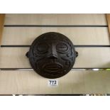 A 19TH/20TH CENTURY IRON WALL MASK OF AZTEC DESIGN, 20CMS DIAMETER