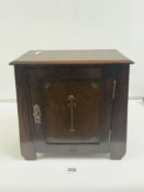 ARTS N CRAFTS OAK SMOKERS CABINET WITH MOTIF DECORATION, FITTED INTERIOR AND PIPE RACK TO SIDE, 35 X
