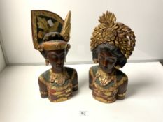 A PAIR OF CARVED AND DECORATED WOODEN BUSTS OF BALINESE MAN AND WOMAN, 40CMS