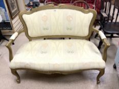 A FRENCH SHAPED SALON SOFA CHAIR PAINTED GOLD WITH CREAM UPHOLSTERY ON CABRIOLE LEGS