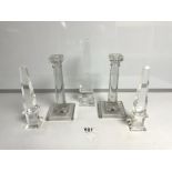 A PAIR OF MOULDED GLASS COLUMN CANDLESTICKS, 21CMS AND THREE GLASS OBELISKS, THE TALLEST 25.5CMS