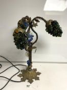 A 1930S BRASS AND IRON THREE BRANCH TABLE LIGHT WITH BUNCHES OF GLASS GRAPE FORM SHADES AND GLASS