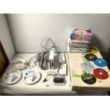A NINTENDO WII FIT IN BOX AND A QUANTITY OF WII GAMES AND CONTROLLERS AND LEADS