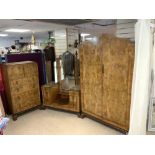 A 1930S WALNUT ART DECO BEDROOM SUITE - COMPRISING OF A TALLBOY, DRESSING TABLE, AND WARDROBE