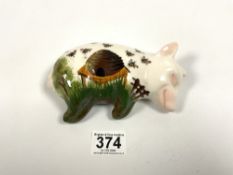 WEMYSS, GRIMELDA HILL POTTERY LYING DOWN PIG DECORATED WITH A HIVE AND BEES