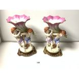 A PAIR OF 20TH CENTURY CERAMIC FIGURES OF CHERUBS HOLDING SHELL, BEARING THE SEVRES MARK TO BASE,