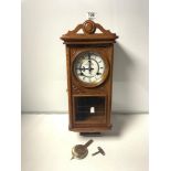 A 1930S STYLE OAK WALL CLOCK MADE BY P.WATTS AND SON CLOCKMAKERS