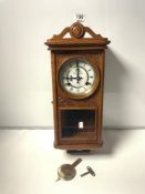 A 1930S STYLE OAK WALL CLOCK MADE BY P.WATTS AND SON CLOCKMAKERS
