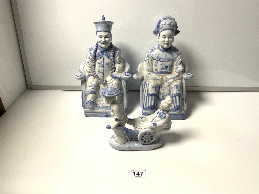 A PAIR OF REPRODUCTION CHINESE BLUE & WHITE FIGURES - SEATED AND FIGURE OF A RICKSHAW, THE TALLEST