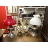 A PAIR OF 19TH CENTURY CERAMIC A GILT METAL OIL LAMPS 35CMS, AND A TWO CHROME OIL LAMPS