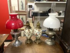 A PAIR OF 19TH CENTURY CERAMIC A GILT METAL OIL LAMPS 35CMS, AND A TWO CHROME OIL LAMPS