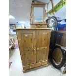 A MODERN PINE BEDROOM CUPBOARD, 92 X 50 X 140CMS, AND A PINE DRESSING TABLE MIRROR