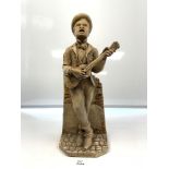 A CONTINENTAL PLASTER FIGURE OF A MAN PLAYING GUITAR, 48CMS