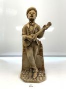 A CONTINENTAL PLASTER FIGURE OF A MAN PLAYING GUITAR, 48CMS