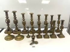 SEVEN PAIRS OF VICTORIAN DIAMOND PATTERN GRADUATING BRASS CANDLESTICKS, THE TALLEST 32CMS, AND