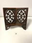 A VICTORIAN GOTHIC CARVED OAK BOOK STAND WITH CARVED FRETWORK DESIGN