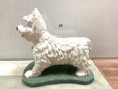 A PAINTED STONE GARDEN FIGURE OF A WEST HIGHLAND TERRIER, 38 X 40CMS
