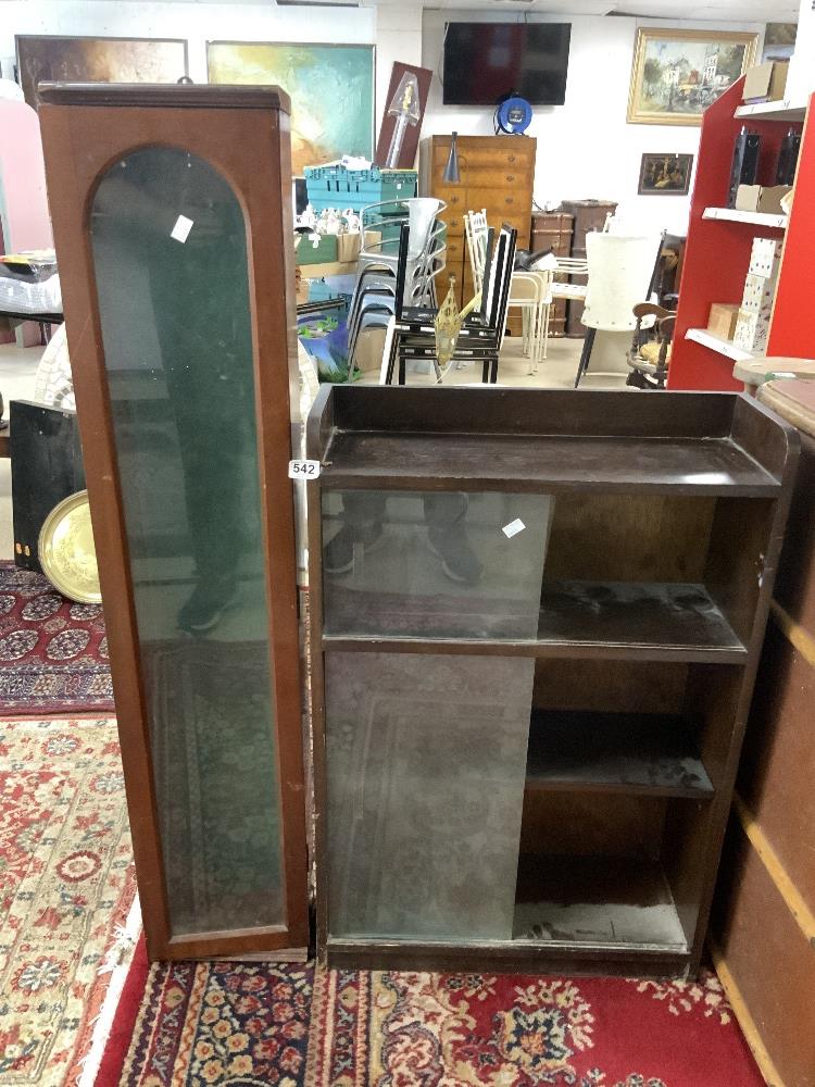 A SLIM GLAZED MAHOGANY GUN CABINET 20 X 128CMS AND A DWARF OAK BOOKCASE WITH SLIDING GLASS DOORS