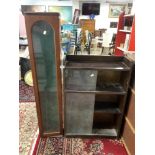 A SLIM GLAZED MAHOGANY GUN CABINET 20 X 128CMS AND A DWARF OAK BOOKCASE WITH SLIDING GLASS DOORS