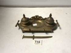 EMBOSSED BRASS DOUBLE INKSTAND AND A BRASS LETTER KNIFE.