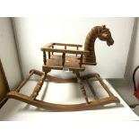 A CHILDS CARVED WOODEN ROCKING HORSE CHAIR