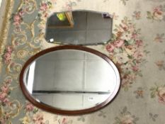 A 1930S OVAL MAHOGANY BEVELLED WALL MIRROR, 79 X 54CMS, AND AN UNFRAMED BEVELLED WALL MIRROR