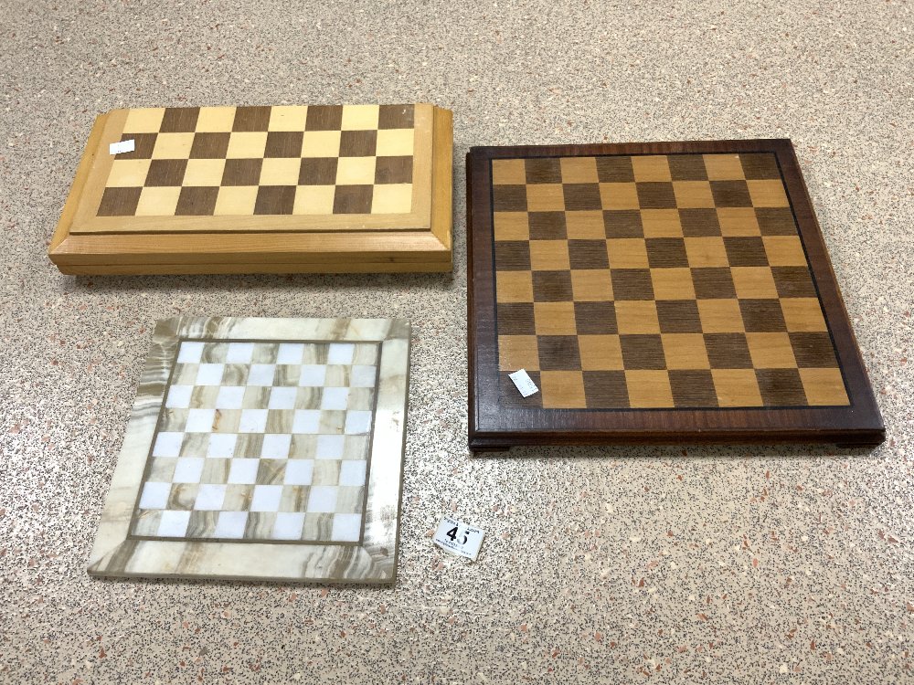 A METAL CHESS SET IN A BOX AND TWO CHESS BOARDS