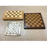 A METAL CHESS SET IN A BOX AND TWO CHESS BOARDS