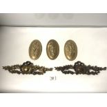A SET OF THREE OVAL BRASS PLAQUES - EMBOSSED WITH THE THREE GRACES 18 X 10CMS AND TWO ORNATE
