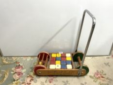 A VINTAGE TRI-ANG 'BUSY BABY' PUSH ALONG TOY WITH BLOCKS