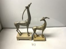 TWO SILVERED STYLIZED FIGURES OF DEER ON ALABASTER BASES, THE TALLEST 43CMS, FROM THE KINDU