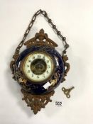 A BLUE AND GILT PORCELAIN HANGING CLOCK WITH GILT METAL MOUNTS ON CHAIN, 22CMS IN DIAMETER