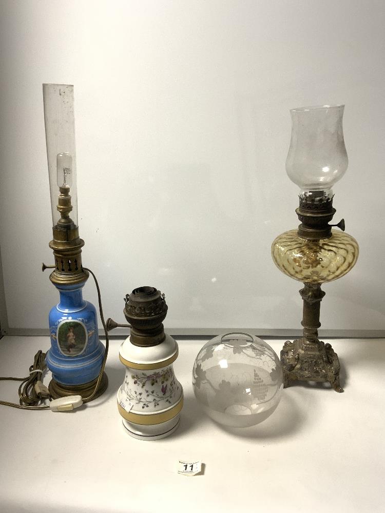 A METAL BASE AND GLASS FRONT OIL LAMP, A CERAMIC OIL LAMP, A BLUE CERAMIC OIL LAMP CONVERTED TO