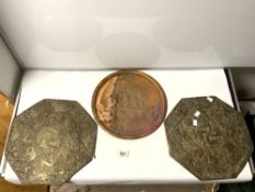 A PAIR OF INDIAN EMBOSSED DECORATED BRASS OCTAGONAL PLAQUES, 36CMS AND A CIRCULAR ENGRAVED COPPER