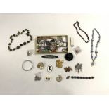 A QUANTITY OF GLASS BEADS, CERAMIC NECKLACES, BROOCHES VARIOUS, WHITE METAL BROOCHES ETC
