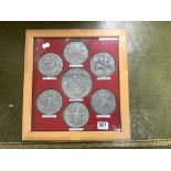 A SET OF SEVEN GERMAN PEWTER CAST MEDIVAL DESIGN CIRCULAR PLAQUES